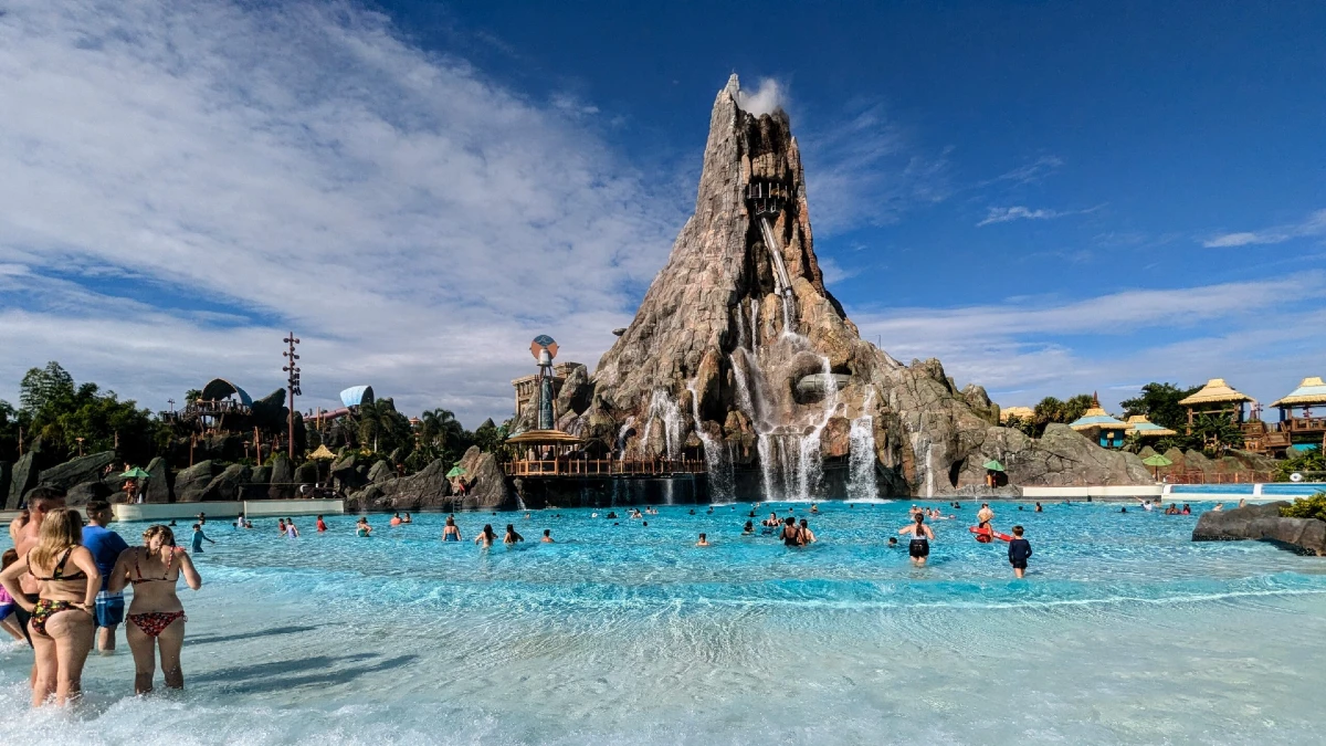 A volcanic mountain near the pool and people enjoying in it