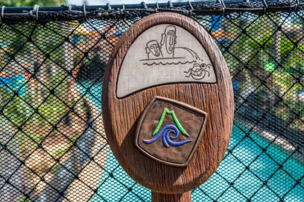 A wooden board having a Volcano Bay sign