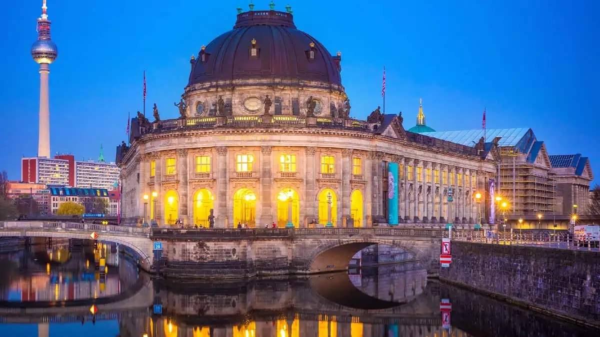 Bode-Museum-in-Berlin Bode Museum in Berlin illuminated at dusk, reflected in the Spree River with the Berlin TV Tower visible in the background