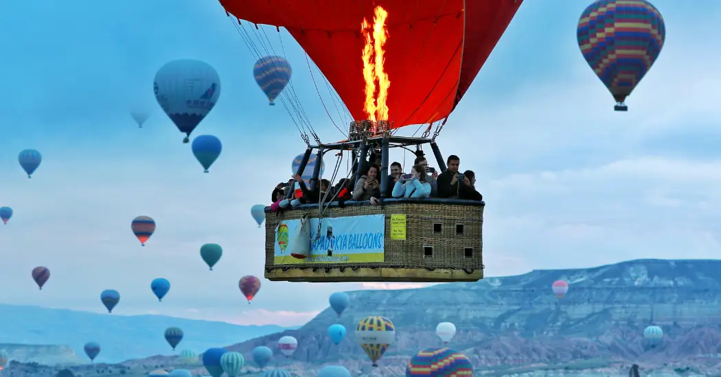 Group of people enjoying their hot air balloon ride over Cappadocia