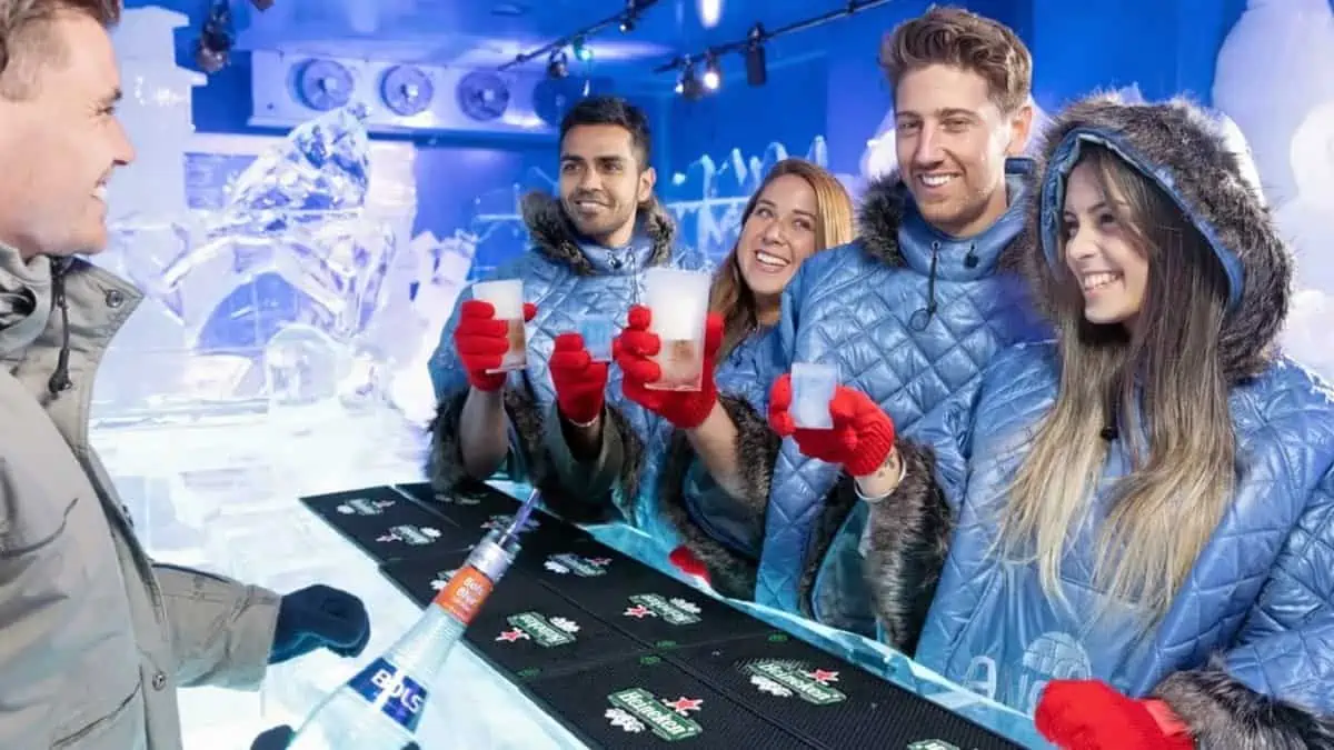 Icebar-Berlin Friends in blue parkas and red gloves drinking at the Berlin Icebar