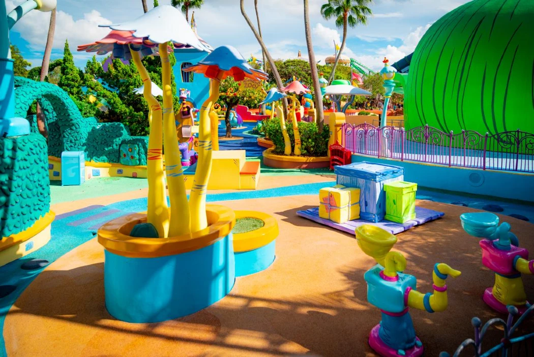 A colorful playground with trees and sculptures