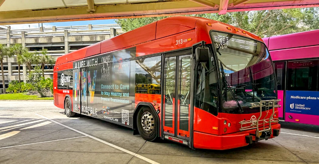 A red colored LYNX Public Bus