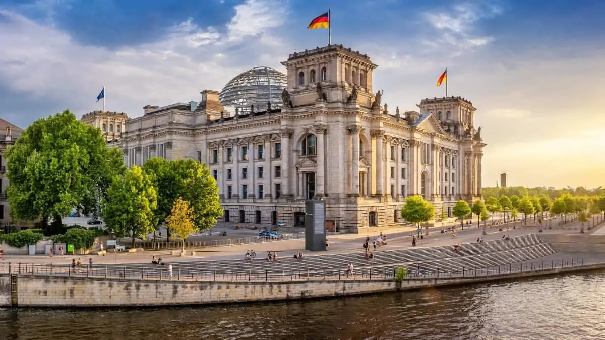 Reichstag-Building Reichstag building in Berlin with glass dome and German flags beside the river